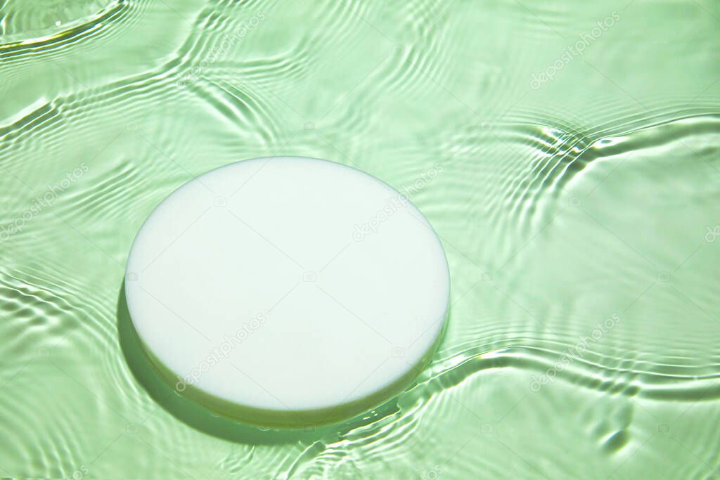 Empty white circle podium on transparent green clear water background