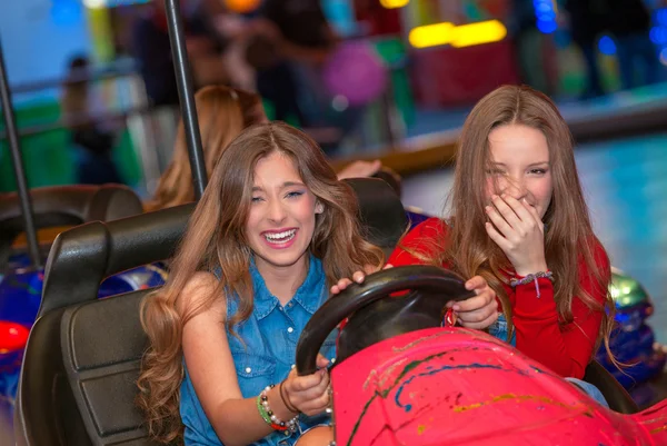 Teens at fun fair riding dodgems — Stock Photo, Image
