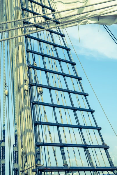 Sails and tackles of a sailing vessel on a background of the sky — Stock Photo, Image