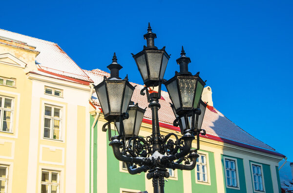 Beautiful street lamp on the background of old buildings