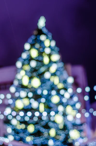 Decorated Christmas tree. Blurred lights background — Stock Photo, Image