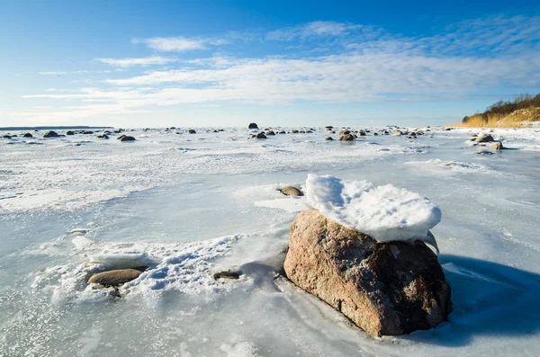 Stones in the ice on the Baltic Sea coast — Stock Photo, Image