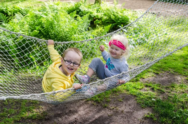 Children swinging in a hammock — Stock Photo, Image