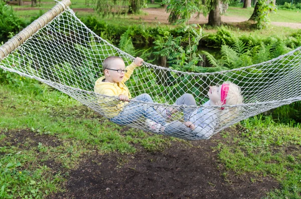 Children swinging in a hammock — Stock Photo, Image