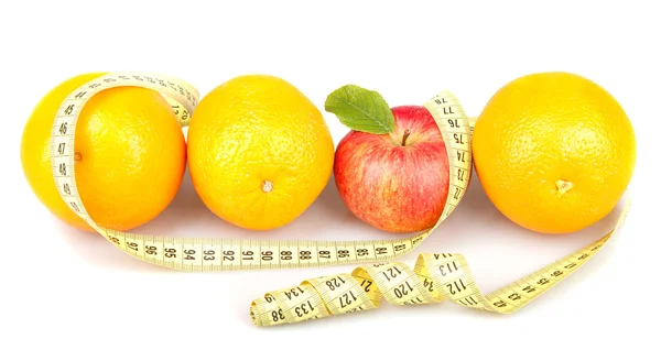 Red apple between three oranges and measuring tape — Stock Photo, Image