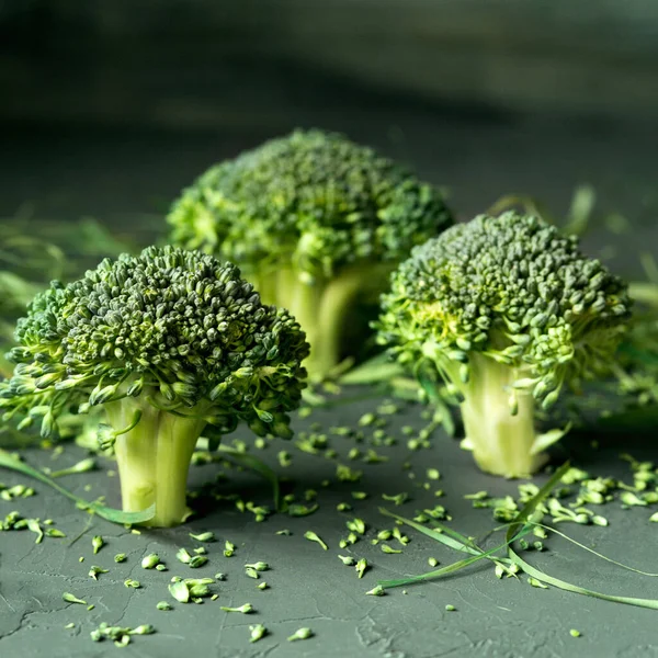 Still-life.Raw broccoli. Green vegetables on a dark background. Vegan food. Raw food diet.