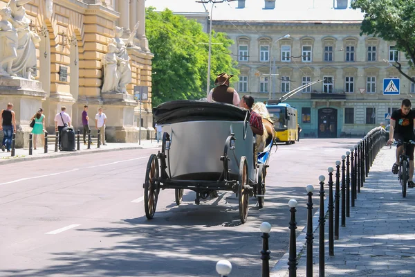 Tourist carriage with people on the streets in historical city c — Stock Photo, Image