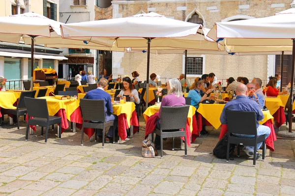 Turiștii se odihnesc la mese într-o cafenea în aer liber din Veneția, Italia — Fotografie, imagine de stoc