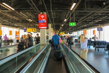  Interior of Amsterdam Airport Schiphol. Passengers on a long ho