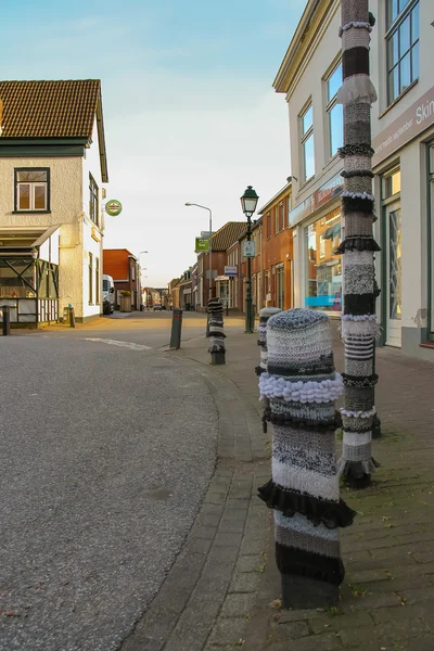 Roadside pillars decorated with knitted clothes in the Dutch tow — Stock Photo, Image