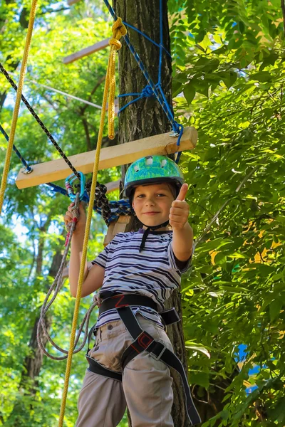 Brave little boy having fun at adventure park and giving  thumbs — Stock Photo, Image