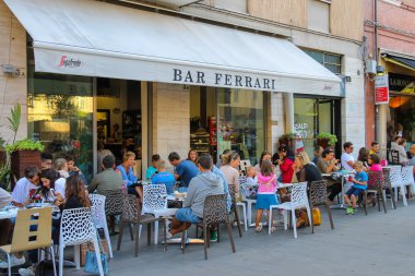 People sitting in Ferrari bar on Luigi Ferrari square (Piazza Lu