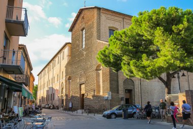 Tourists walking near the ancient catholic church (Chiesa Cattol
