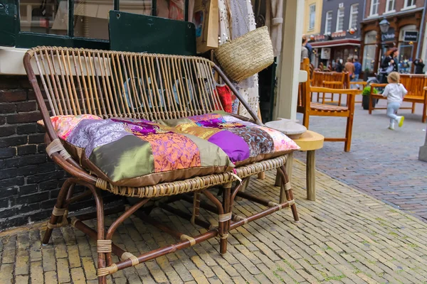 Wicker sofa with colorful pillows in the historic center of Haar — Stock Photo, Image