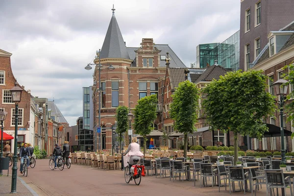 People riding a bike in the historic center of Haarlem, the Neth — Stock Photo, Image