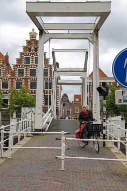 People on the drawbridge over Spaarne river in Haarlem, the Neth