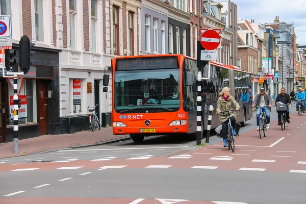 Riding a bike people and big bus in the historic center of Haarl — Stock Photo, Image