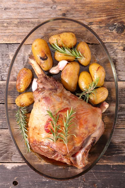 Roasted lamb leg and potatoes — Stock Photo, Image