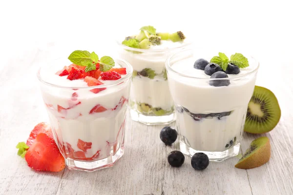Yogurt and fruits in glasses — Stock Photo, Image