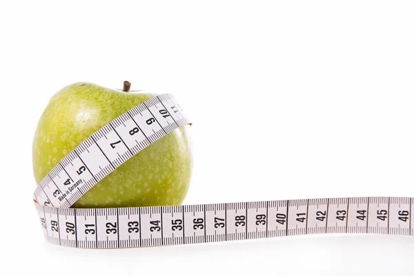 Green apple and measure tape — Stock Photo, Image