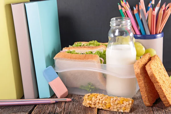 Sandwich, milk and books — Stock Photo, Image