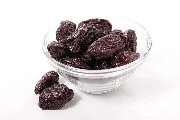 Dried plums in bowl — Stock Photo, Image