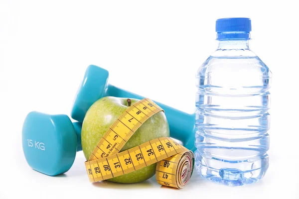 Dumbbell, tape measure, water and apple — Stock Photo, Image
