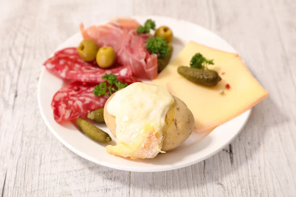 Raclette cheese melted with potato and meat — Stock Photo, Image