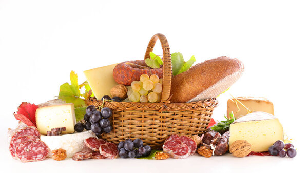 wicker basket with selection of cheese and bread isolated on white background