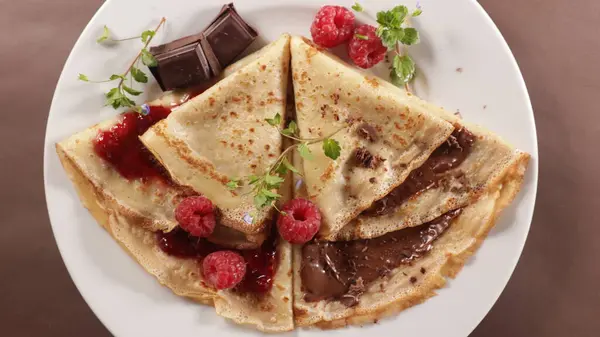 crepe with chocolate spread and raspberry fruit jam