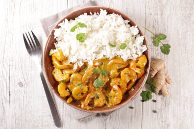 Krema ve köri ile pişirilmiş karides. 