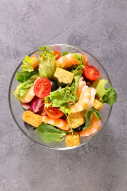 Bir kase karides, marul ve kızarmış ekmek.