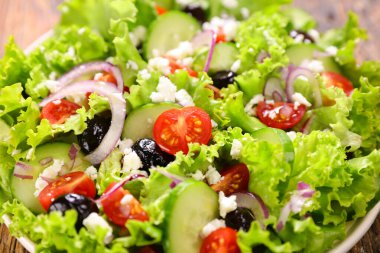 Marul, domates, salatalık ve peynirli sebze salatası.