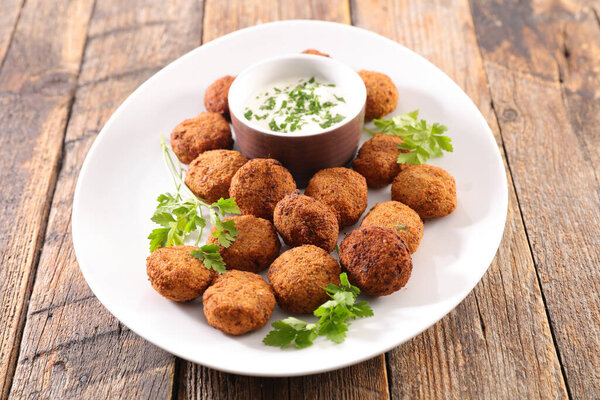 falafel with dipping sauce in plate