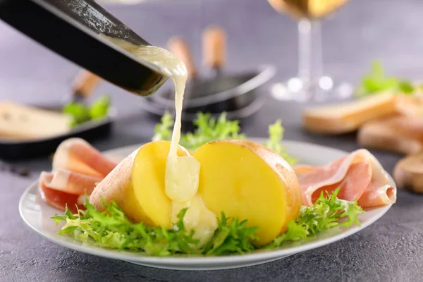 melted cheese with potato, ham and lettuce