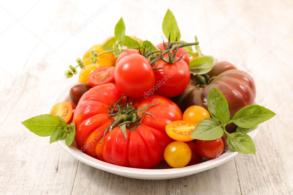 variety of colorful tomato and basil