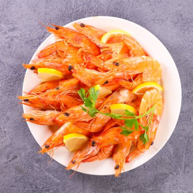 Bir tabak taze karides ve limon.