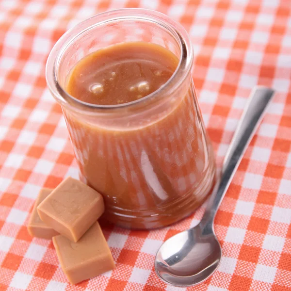 Caramel dessert and spoon — Stock Photo, Image
