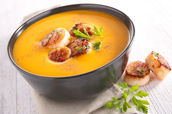Cream of pumpkin soup with scallops — Stock Image Cream of pumpkin soup with scallops Royalty Free Stock Images