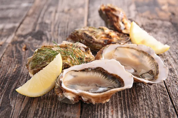 Fresh Oysters on wooden table — Stock Photo, Image