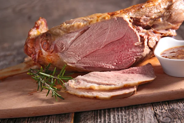 Roast lamb on wooden board — Stock Photo, Image