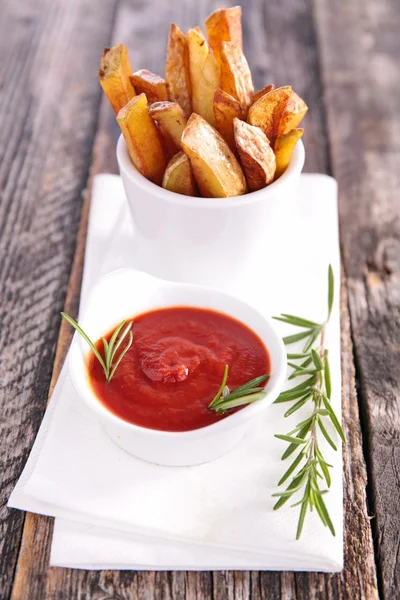 Fried potato with sauce and rosemary — Stock Photo, Image