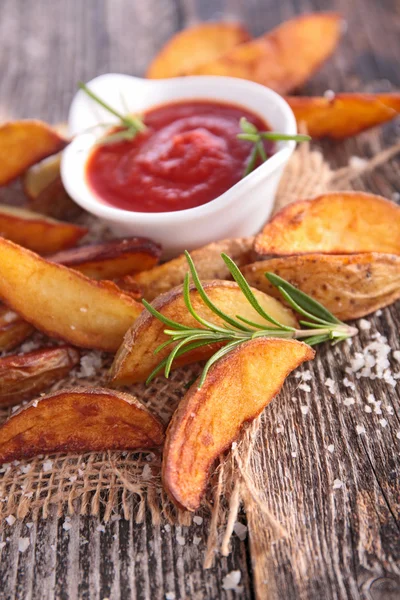 Fried potato with sauce and rosemary — Stock Photo, Image