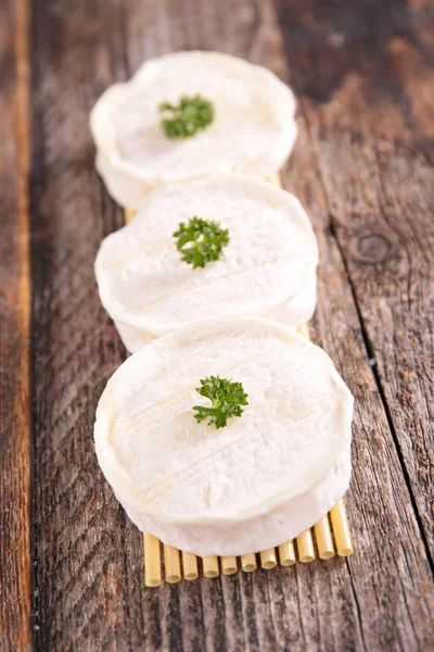 Goat cheese on wooden table — Stock Photo, Image