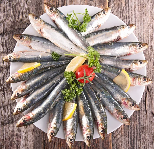 Fresh sardines and tomato — Stock Photo, Image