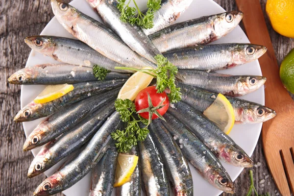 Fresh sardines and tomato — Stock Photo, Image