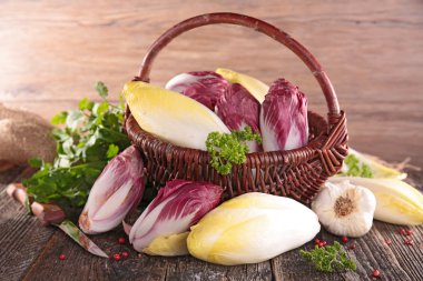 Basket with raw chicory clipart