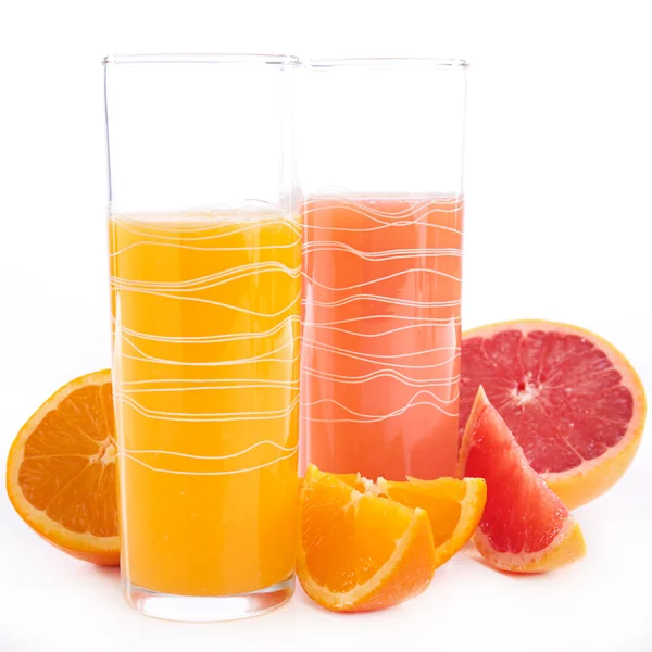 Grapefruit and orange juice in glasses — Stock Photo, Image