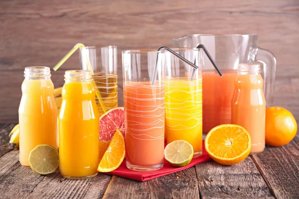 Grapefruit and orange juice in glasses — Stock Photo, Image