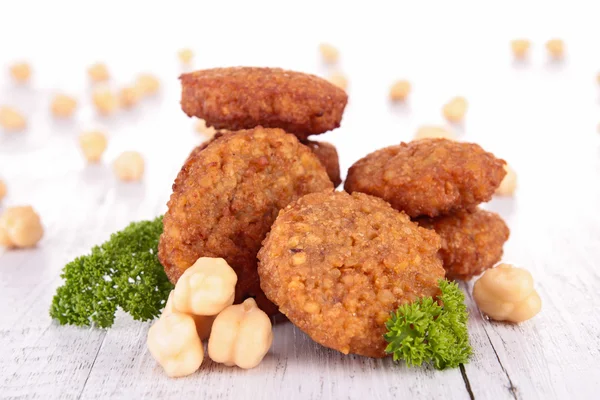 Falafels with parsley on wood — Stock Photo, Image